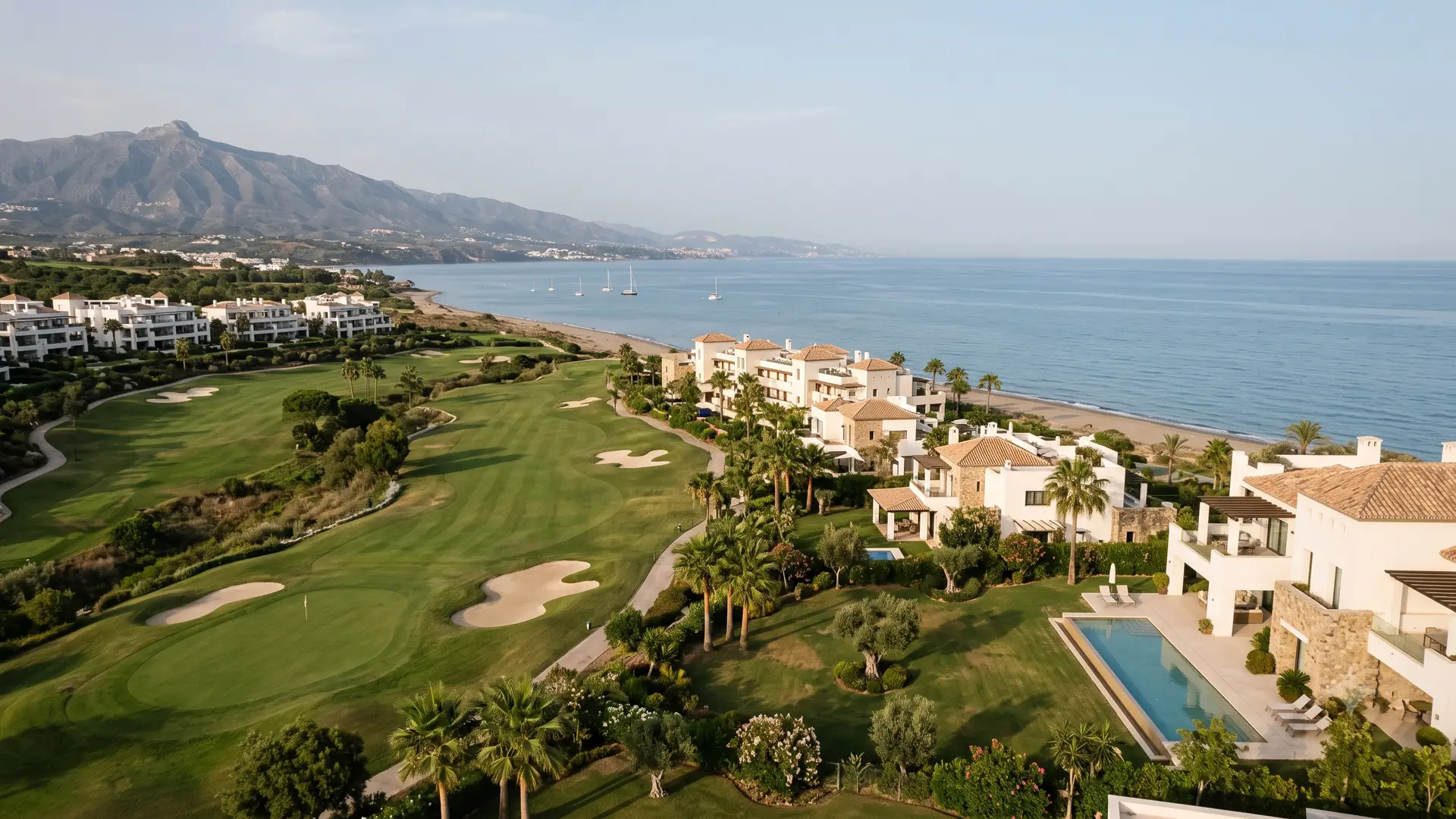 Beachfront golf on the western New Golden Mile near Estepona, with contemporary villas and low apartment blocks set between the fairways and the sand