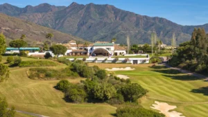 The La Cala Golf estate in the Sierra de Mijas, with fairways and bunkers below the clubhouse and the mountain ridge rising behind