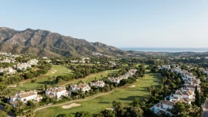 The established golf-side residential landscape of El Paraiso and Atalaya on the eastern New Golden Mile, with the Sierra Bermeja behind and the sea beyond