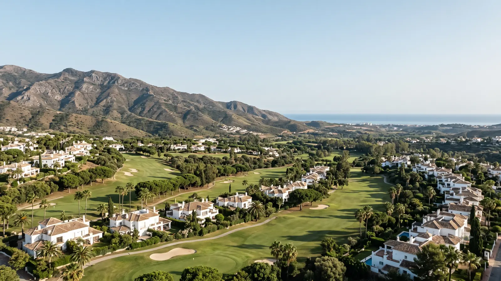 The established golf-side residential landscape of El Paraiso and Atalaya on the eastern New Golden Mile, with the Sierra Bermeja behind and the sea beyond
