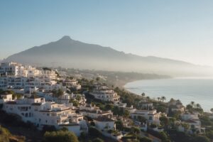 Morning view over white residential buildings in Marbella stepping down to the sea with La Concha mountain behind